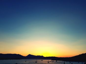 Scenic view of sea against clear sky during sunset