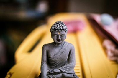 Close-up of stone buddha souvenir