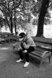 Full length of boy sitting in park