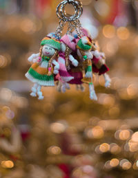 Close-up of key ring with human representation hanging for sale at market