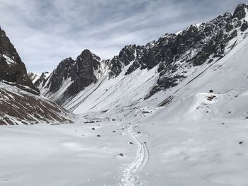 Scenic view of snow covered mountains against sky