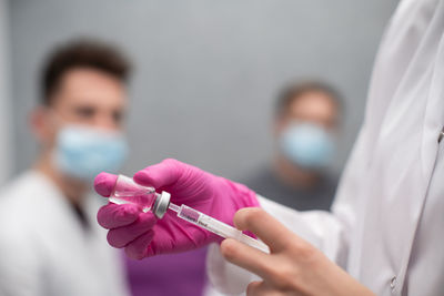 Midsection of doctor examining patient at clinic