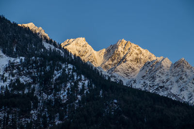 Scenic view of snowcapped mountains against clear sky