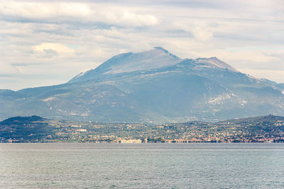 Scenic view of sea and mountains against sky