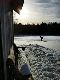 Scenic view of snow covered land against sky during sunset