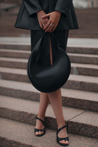 Black leather trendy cloth, handbag and silver accessories. fancy outfit, female fashion accessories