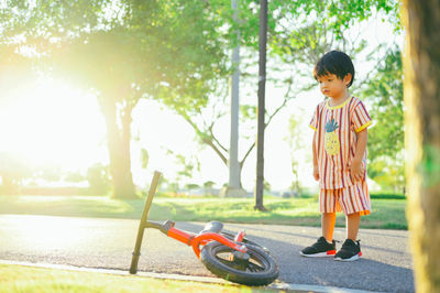 Rear view of boy standing on road