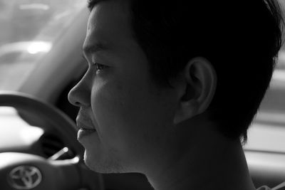 Portrait of young woman in car