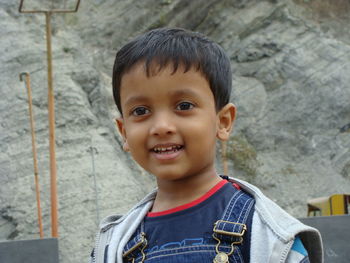 Close-up of smiling boy looking away