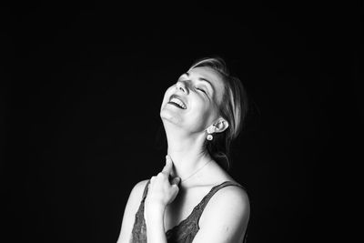 Smiling woman against black background