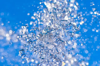 Full frame shot of water drops on blue background