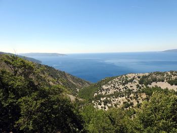 Scenic view of sea and mountains against sky