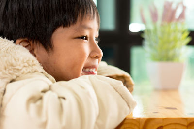 Close-up portrait of cute boy at home