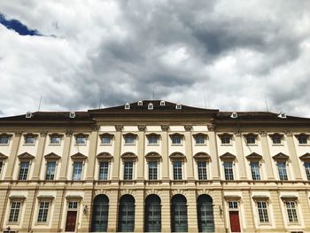 Low angle view of building against cloudy sky