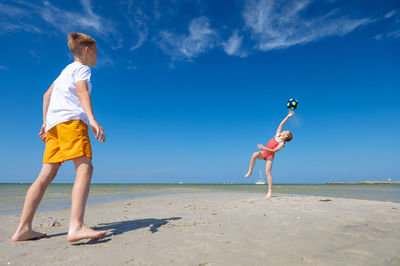 Full length of woman on beach against sky