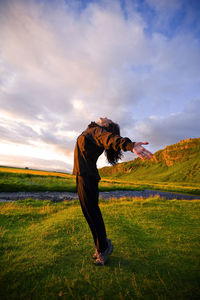 Chinese woman stretching at sunset in iceland