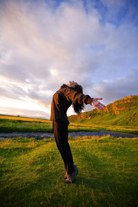 Man standing on field against sky