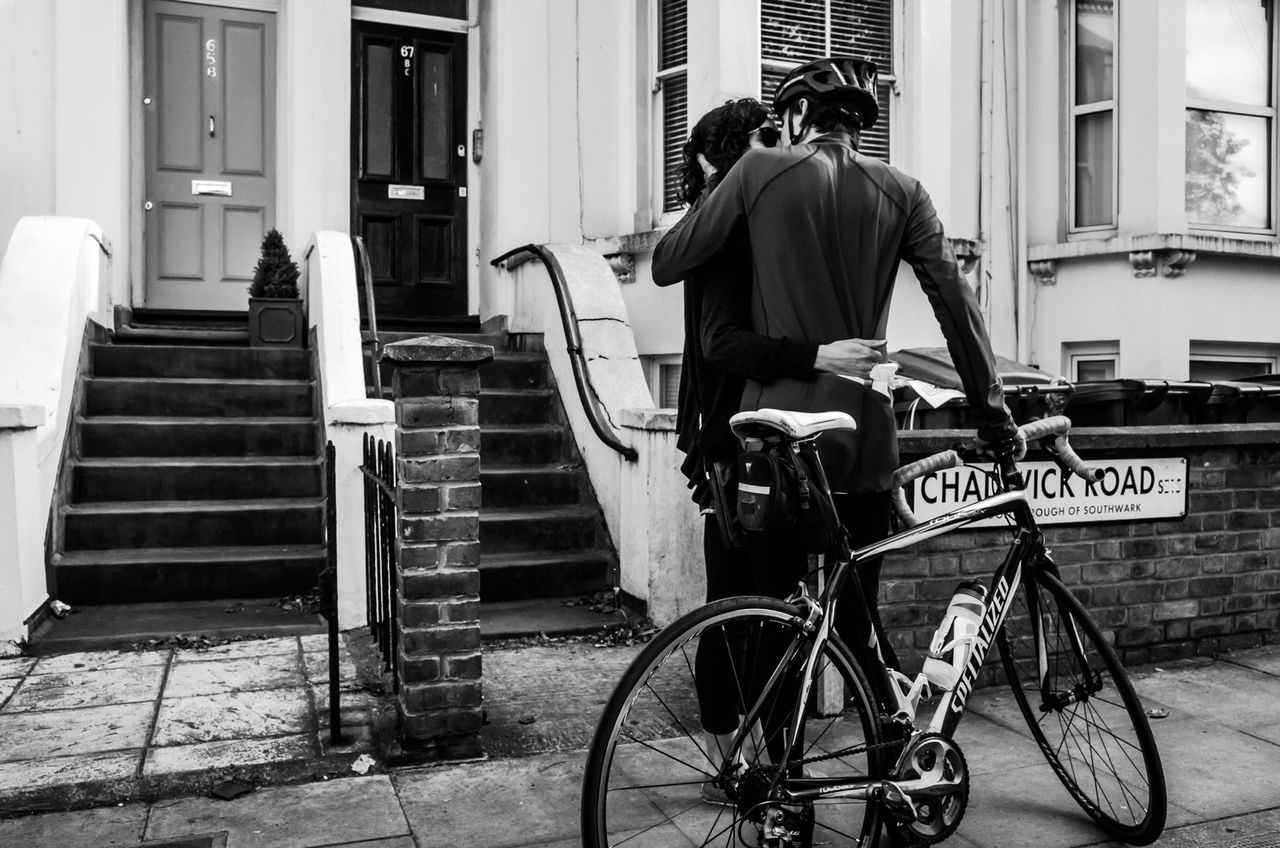 building exterior, bicycle, architecture, built structure, full length, transportation, mode of transport, men, land vehicle, side view, lifestyles, casual clothing, rear view, city, street, building, city life, leisure activity