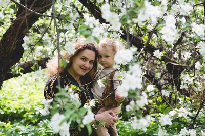 Portrait of young woman in plant