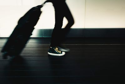 Low section of person walking on zebra crossing