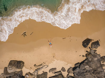 Aerial view of man lying on the beach