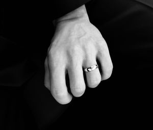 Close-up of woman hand against black background