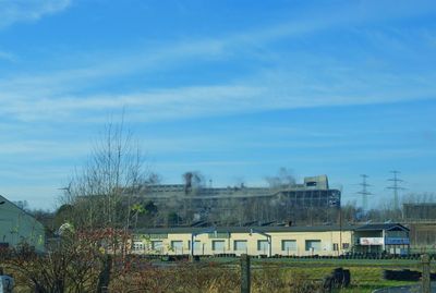 Built structure on landscape against blue sky