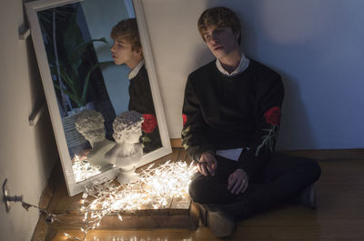 Rear view of man standing by wall