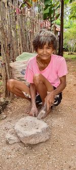 Portrait of senior man sitting on field