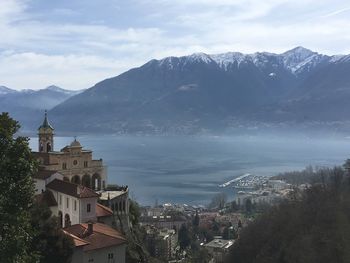 Townscape by mountains against sky