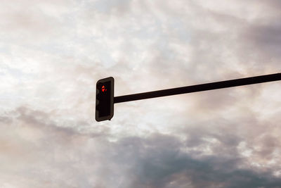 Low angle view of road signal against sky