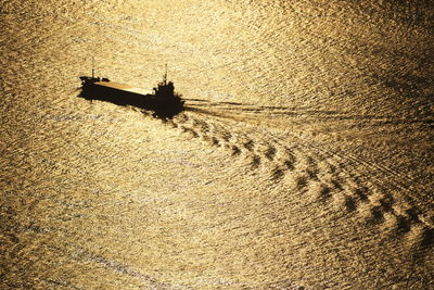 Silhouette ship on sea during sunset