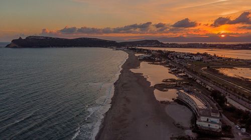 Scenic view of beach against sky during sunset