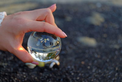 Close-up of hand holding crystal ball