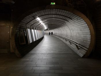 Rear view of man walking in subway