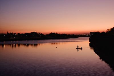 Scenic view of lake against orange sky