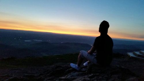 Scenic view of mountains against clear sky during sunset