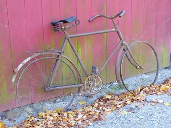 Close-up of bicycle parked against wall
