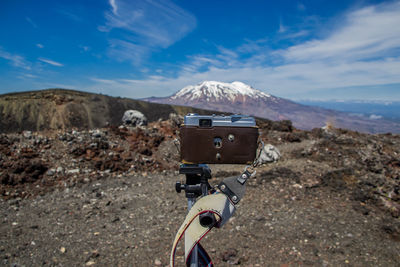 Rear view of man riding motorcycle on mountain against sky