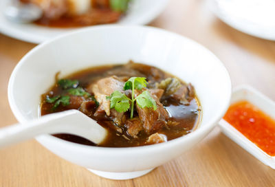 Close-up of pork soup on table