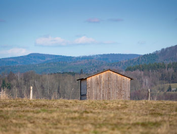 Built structure on field against sky
