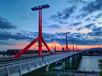 Bridge over river against sky during sunset