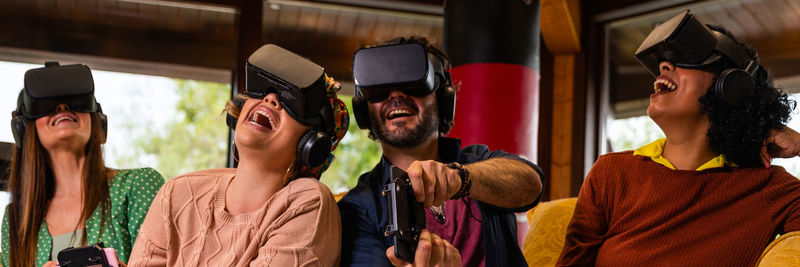 Multiracial young students and diverse friends wearing virtual reality glasses horizontal web banner