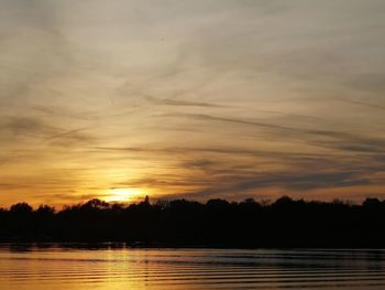 Scenic view of lake against romantic sky at sunset