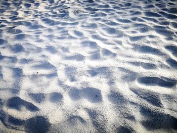 High angle view of footprints on sand