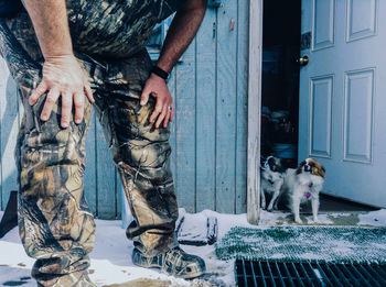 Two little dogs at the door step looking at their owner in barrow, alaska.