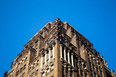 Low angle view of historic building against clear blue sky