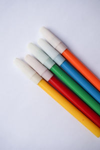 High angle view of colorful felt tip pens on white background