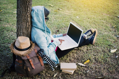 High angle view of person using laptop while sitting at park