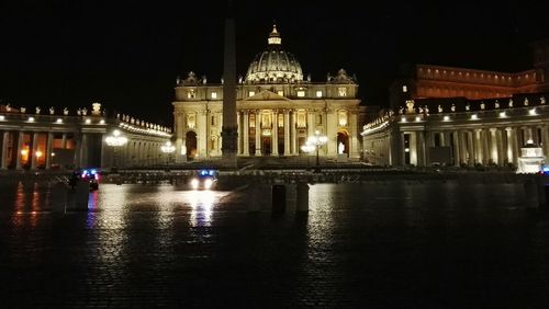 Reflection of illuminated building in water at night